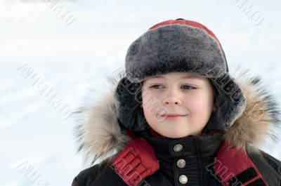 Portrait of a boy in a jacket with fur