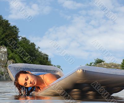 beautiful woman with an air mattress in the water