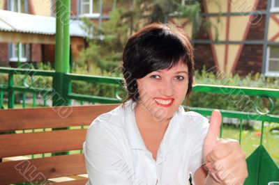 Portrait of attractive young female showing a thumb