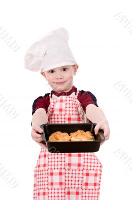 boy in chef`s hat with baking