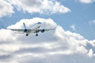 Modern airplane in the sky near airport. 