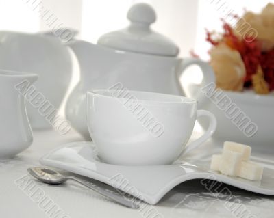 A cup of tea with sugar cubes