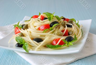 Spaghetti with tomato, capers and basil with olives