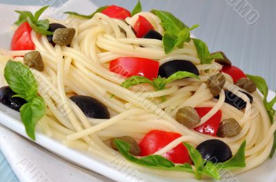 Spaghetti with tomato, capers and basil with olives