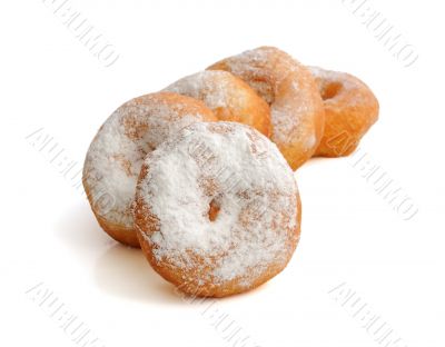 Fried donuts in powdered sugar on a white background