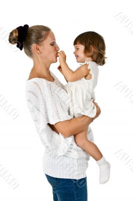 little girl at the hands of the mother feeds her and plum