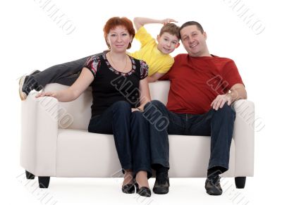 family with son sitting on a sofa
