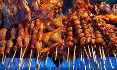grilled skewers of meat and wings