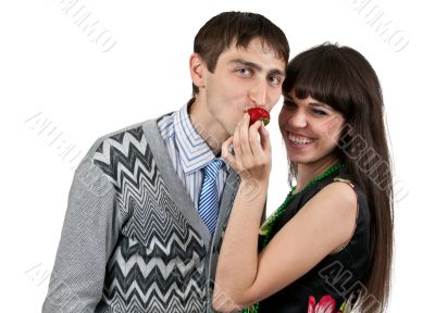 woman feeding man strawberries