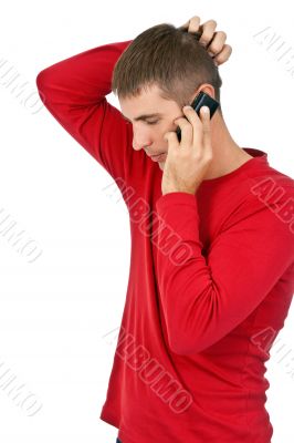 man in a red dress speaks on a mobile phone.