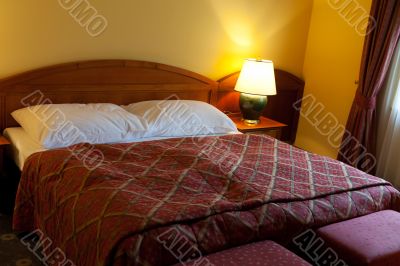 dressed with a red coverlet bed