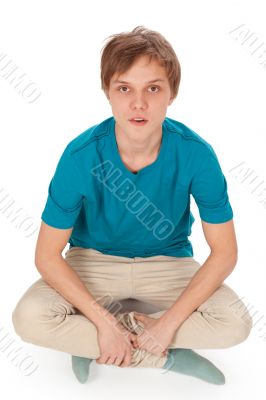 Teen sits on the floor