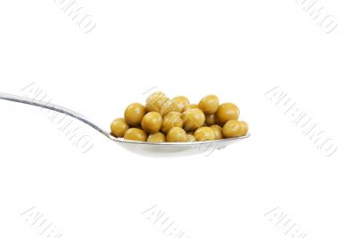 Spoon with green peas