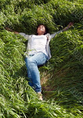 girl lying in the green grass