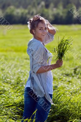 girl with a bundle of green grass
