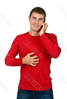 man in a red dress speaks on a mobile phone.