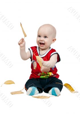 little boy with autumn leaves in the studio