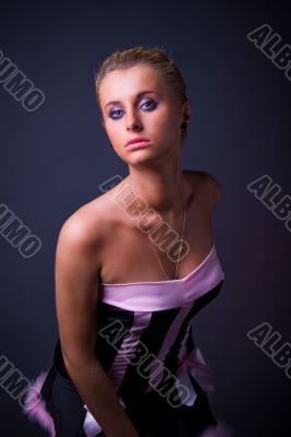 Female model posing in black and pink dress