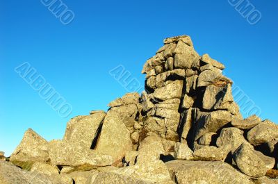 Huge rocks against blue sky