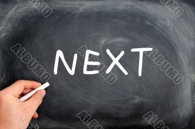 NEXT written on a blackboard