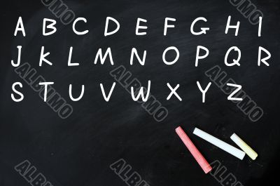 English alphabet handwritten with white chalk on a blackboard