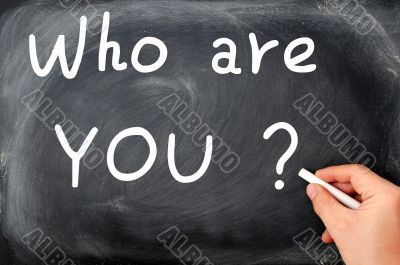 Who are you question written on a blackboard