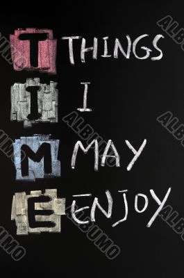 TIME acronym written with chalk on blackboard