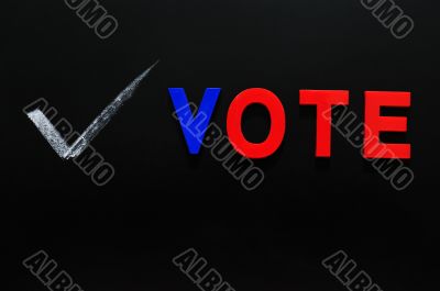 Vote made of colorful lettes on a blackboard