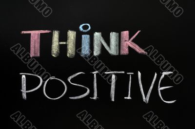 Think positive - text written with chalk on blackboard