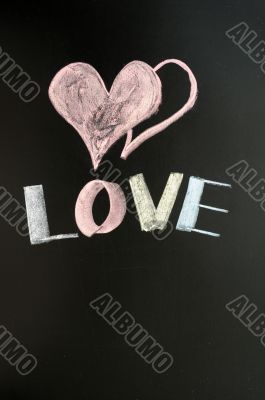 Love with two hearts drawn on a chalkboard