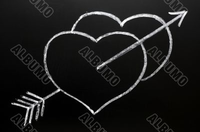 Two hearts with Cupid`s arrow hitting through