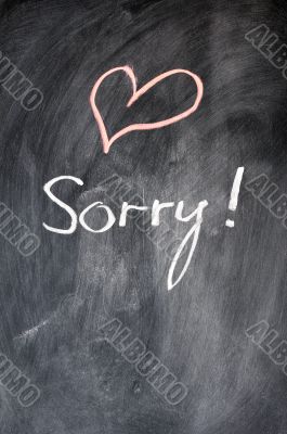 Sorry written on blackboard
