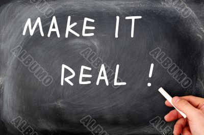 Make it real with a hand holding chalk