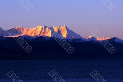 Landscape of snow-capped mountains at lakeside