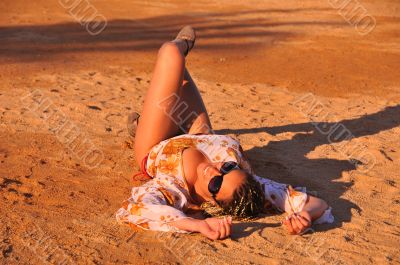 woman lying in the sand