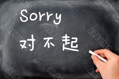 `Sorry` written on a blackboard background with a Chinese version