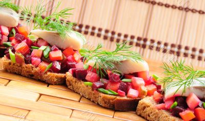Sandwiches with rye bread, herring and vegetables