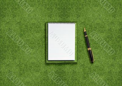 Blank notebook on grass