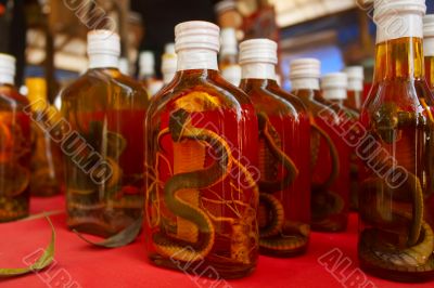 Bottles of whiskey and snakes