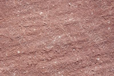 The texture of granite, dark red