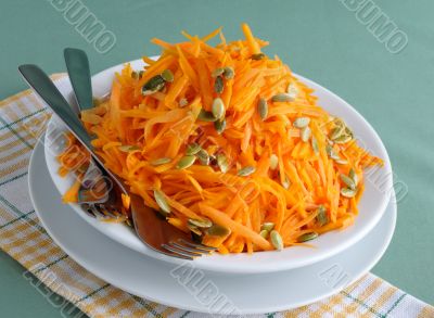 Salad of pumpkin and carrot with pumpkin seeds