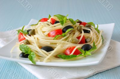 Spaghetti with tomato, capers and basil with olives