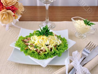 Salad with ham, cucumber, egg under the chips
