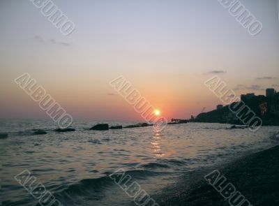 Round sun falling down over the Black sea