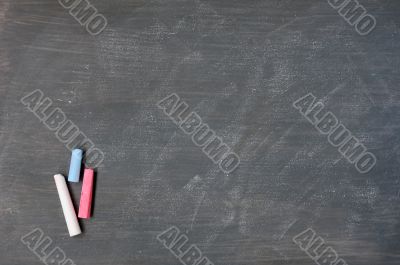Smudged blackboard background with chalk and copy space
