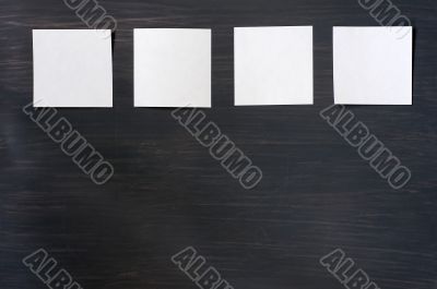 Blank stick note on a blackboard