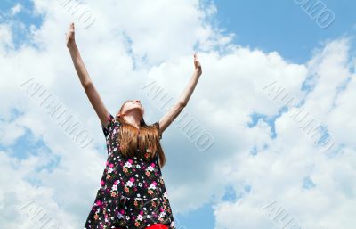 Teen girl with raised hands