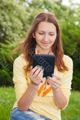 Teen girl reading electronic book