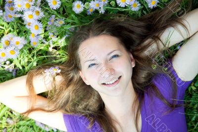 Teen girl laying in grass