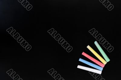Colorful chalk on a blank blackboard